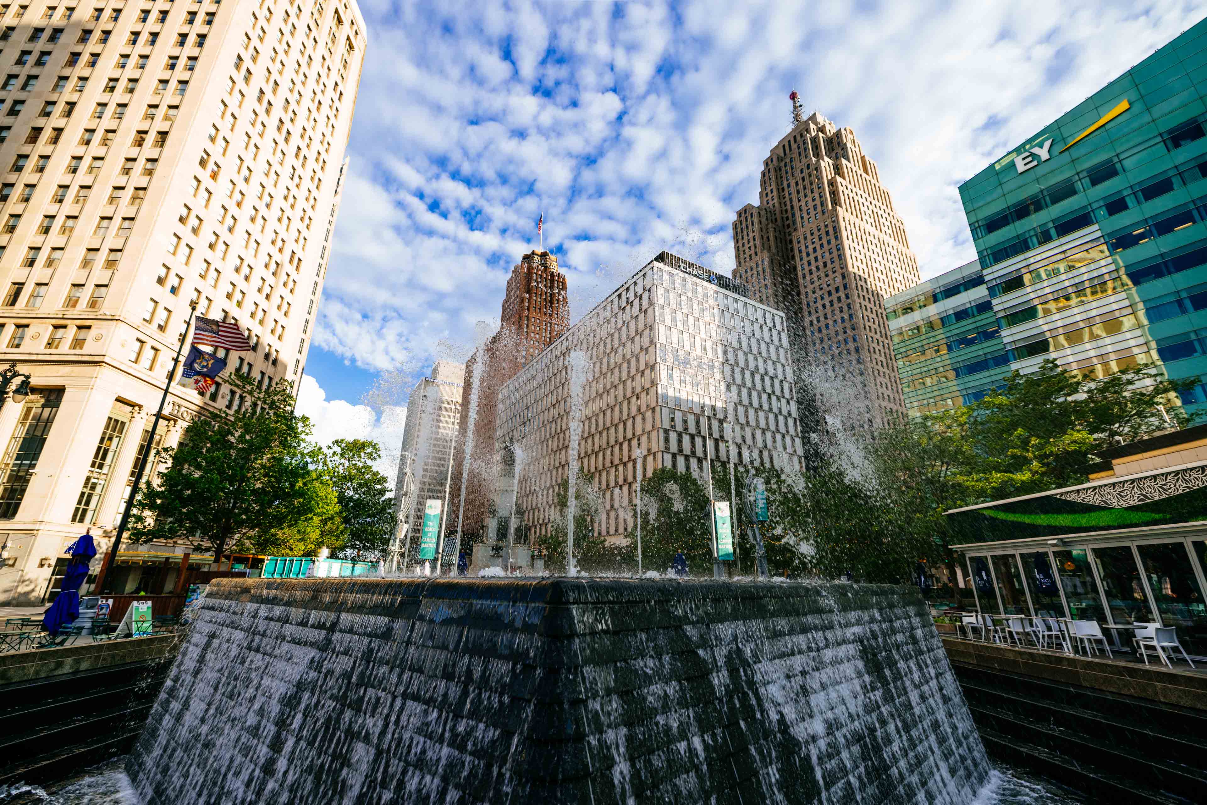 The Woodward Fountain mid-spray at Campus Martius with the Penobscot and Guardian towers behind