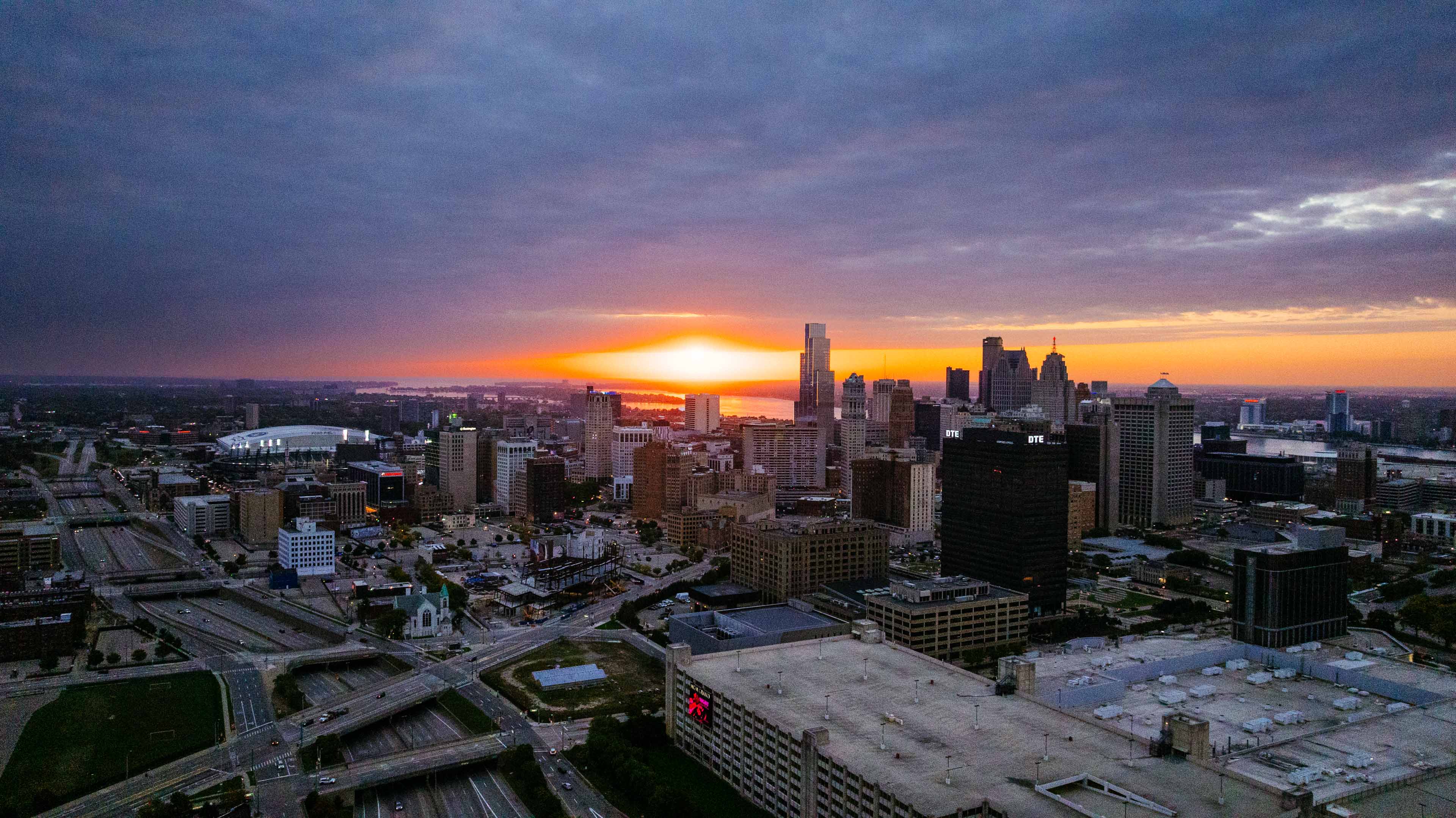 Sunset drone view over downtown Detroit with Ford Field and Comerica Park